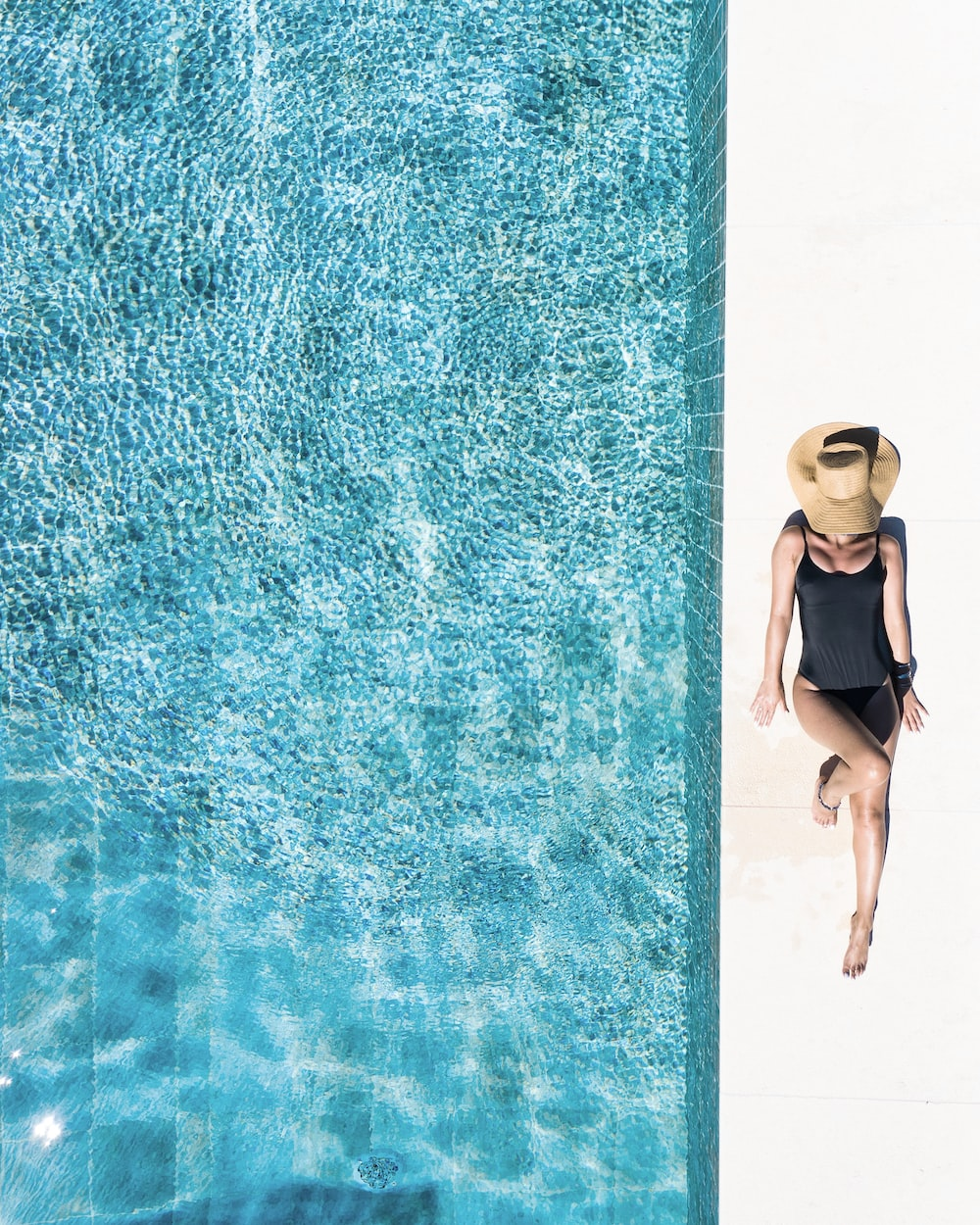 a woman lying by the pool