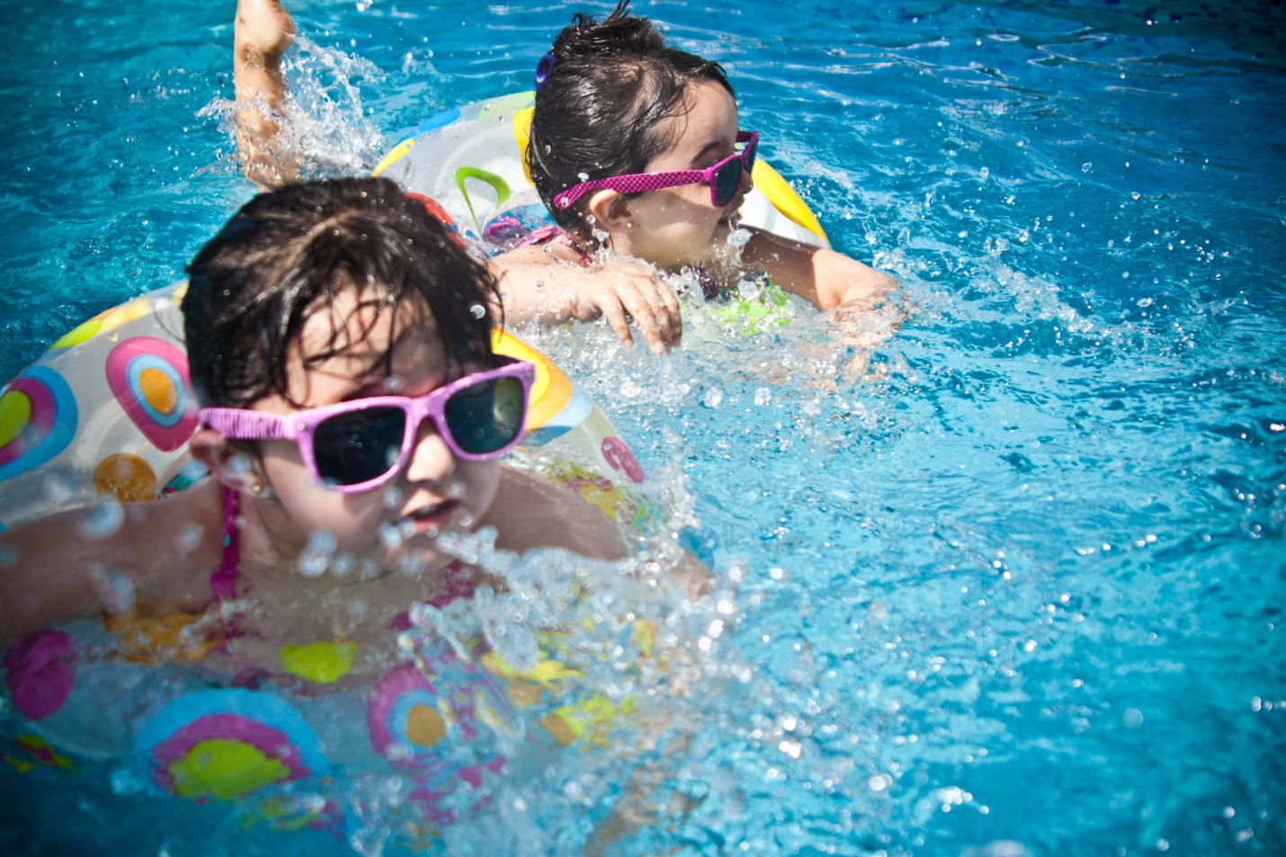 Two kids playing in the swimming pool